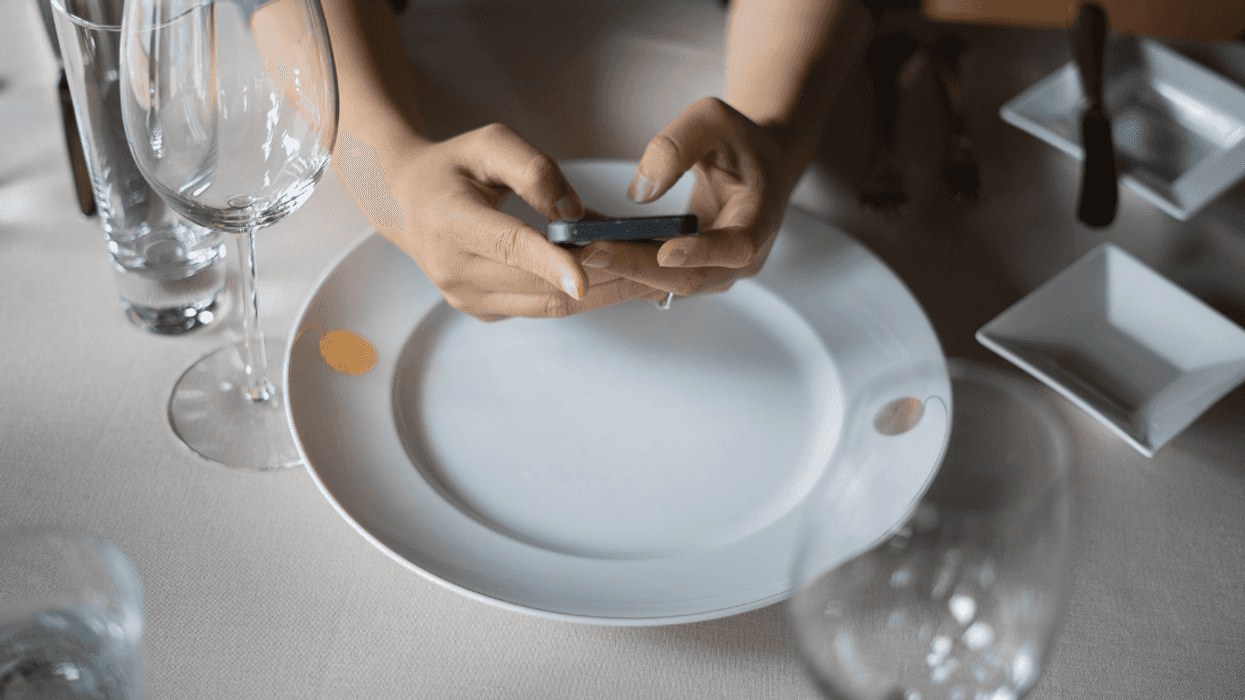 woman using cellphone in restaurant