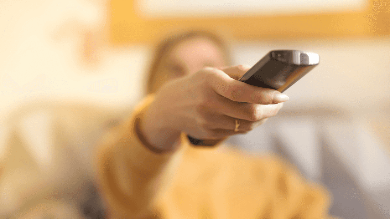 woman using television remote