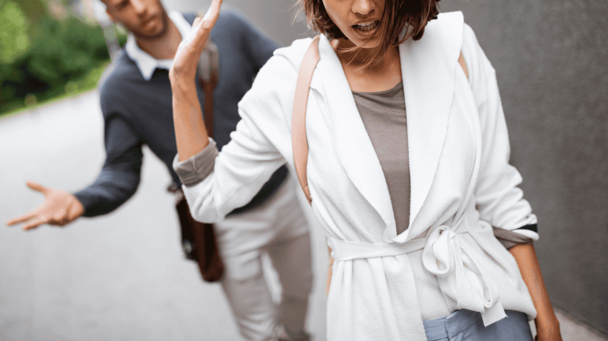 woman walking away from man on street