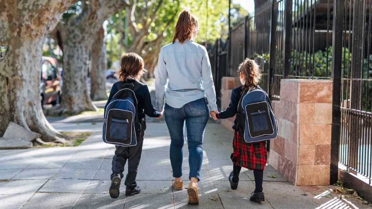 Woman walking with two children