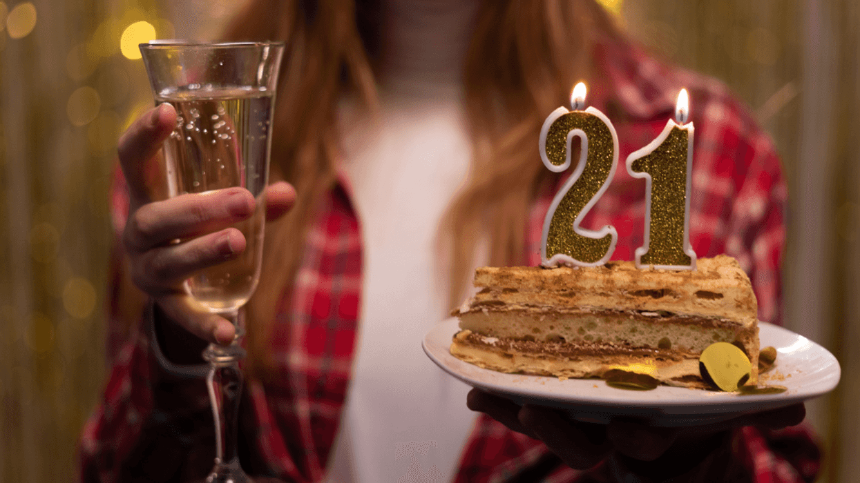 Woman with 21st birthday cake.
