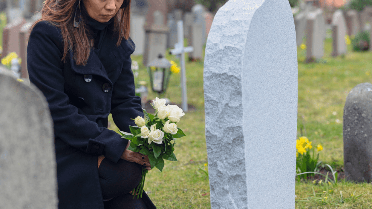 woman with flowers in cemetery