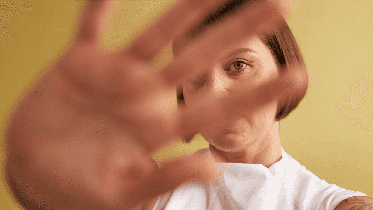 woman with hand up in front of her face