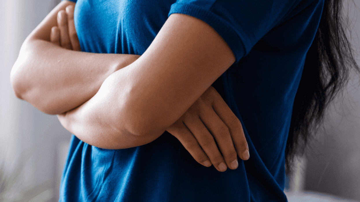 Woman with her arms crossed over her chest