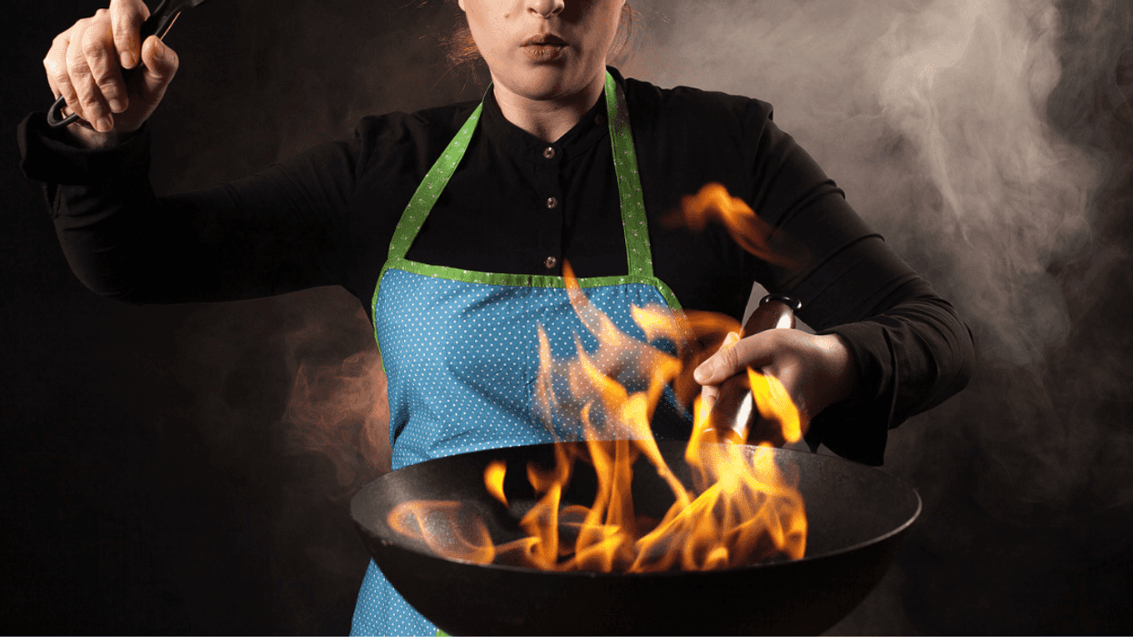 Woman with pan full of fire