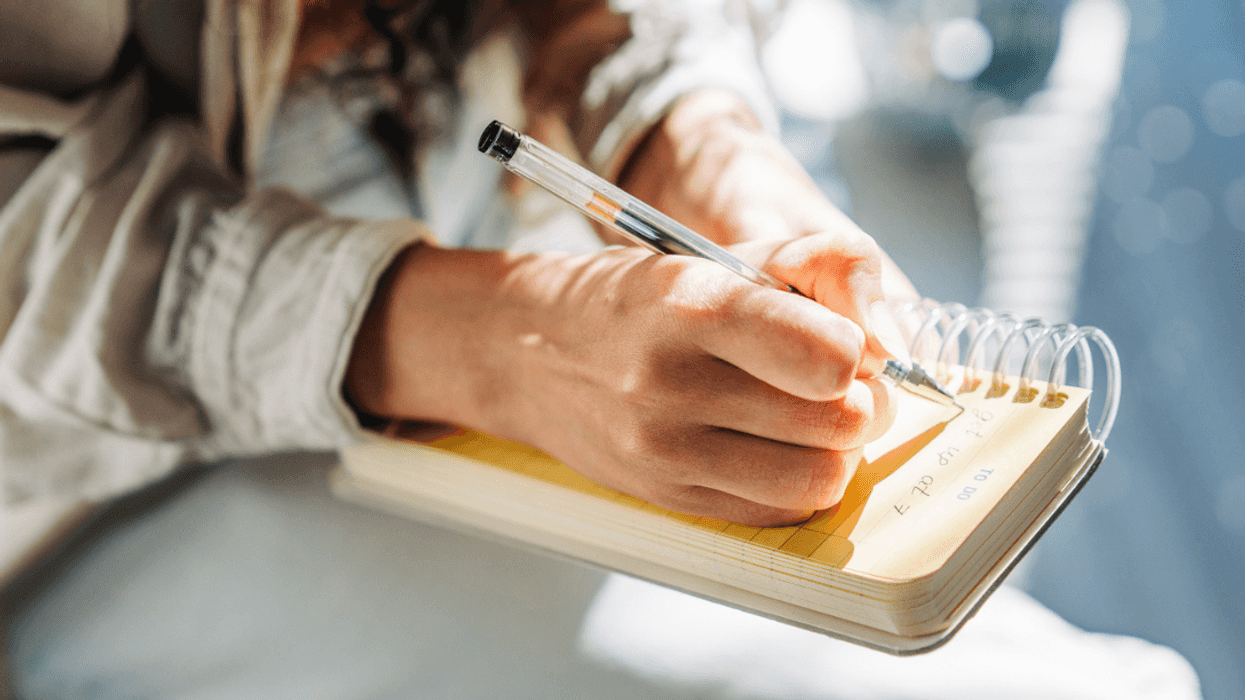 Woman writing in notebook