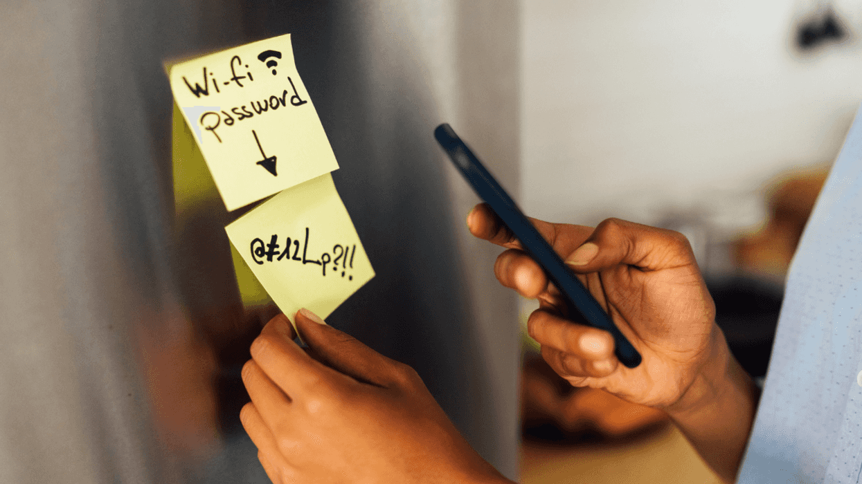 woman writing WiFi password on note