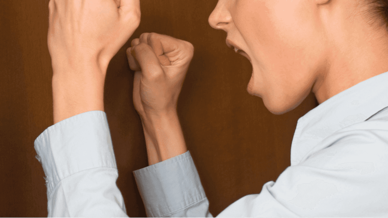woman yelling and pounding on closed door