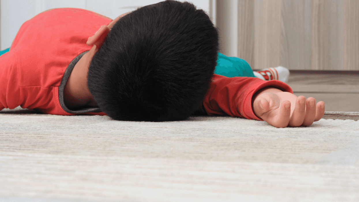 Young boy passed out on the ground