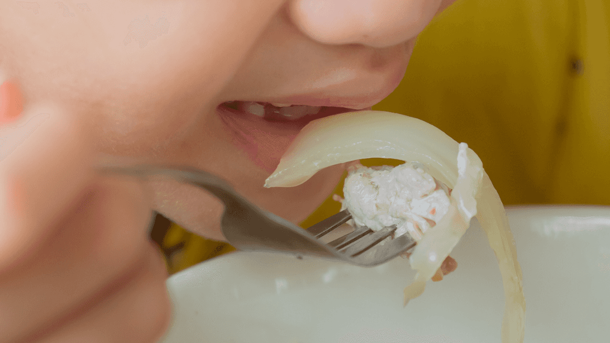 Young child eating an onion
