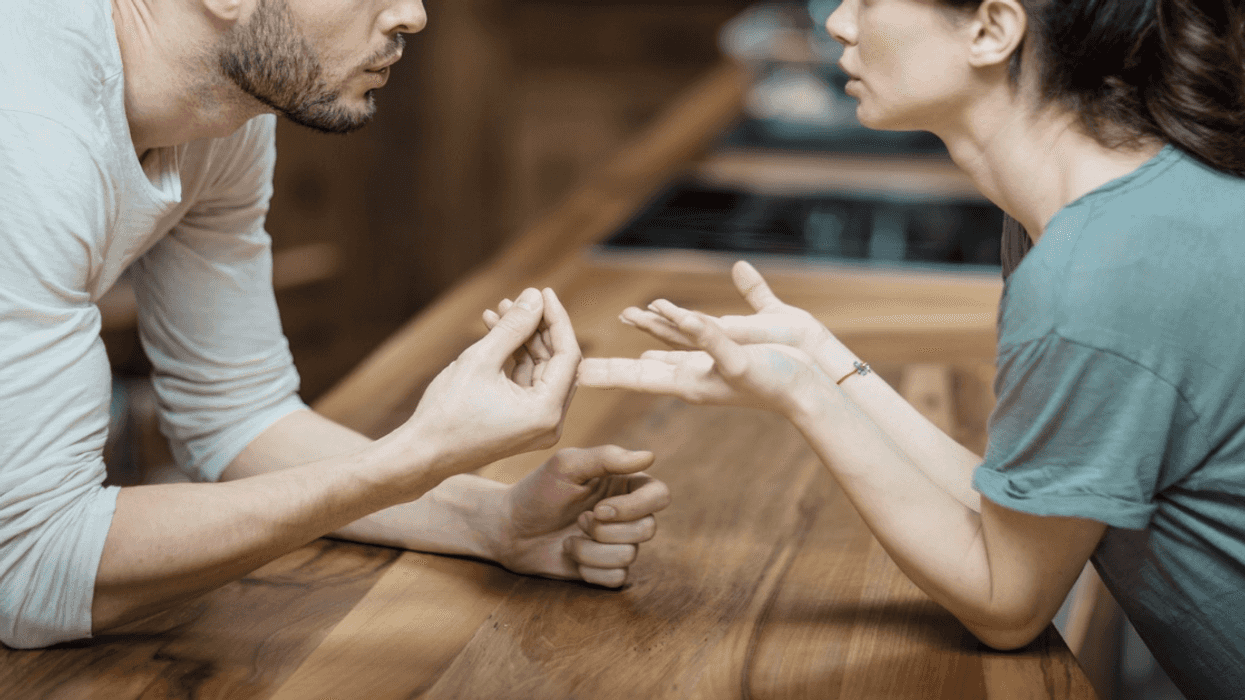 young couple arguing in kitchen