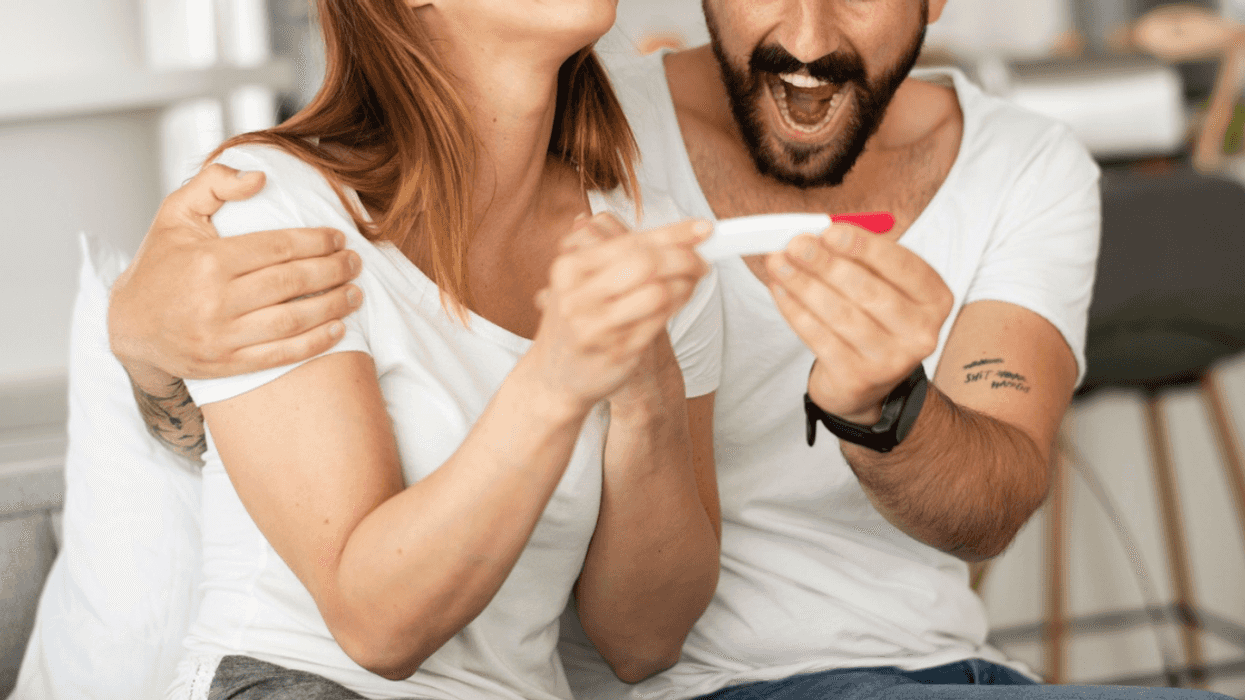 young couple excited about pregnancy test