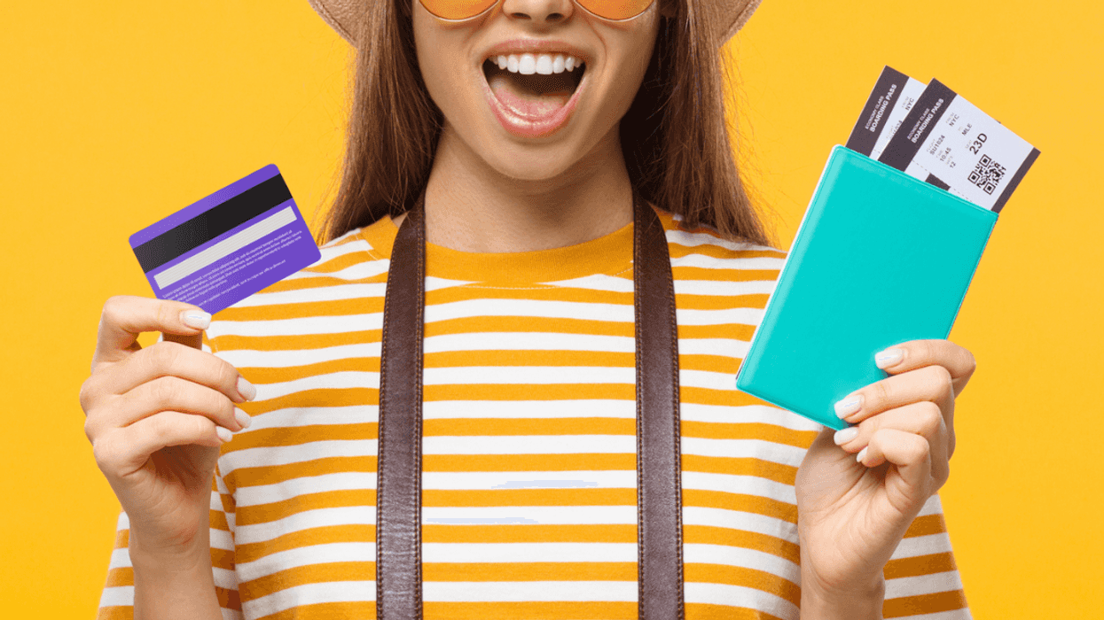 Young girl holding credit card and passport.