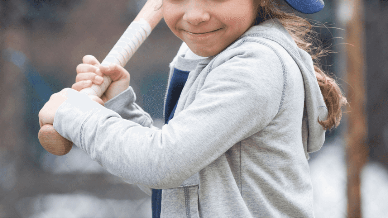 Young girl playing baseball