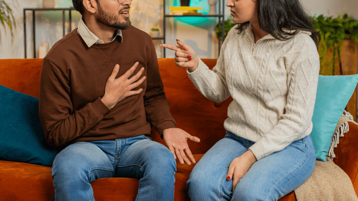young Indian couple arguing on couch