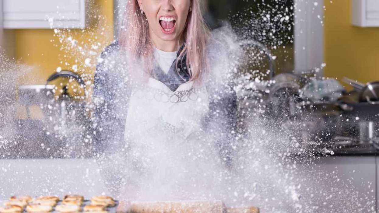 Young lady in a messy kitchen disaster.