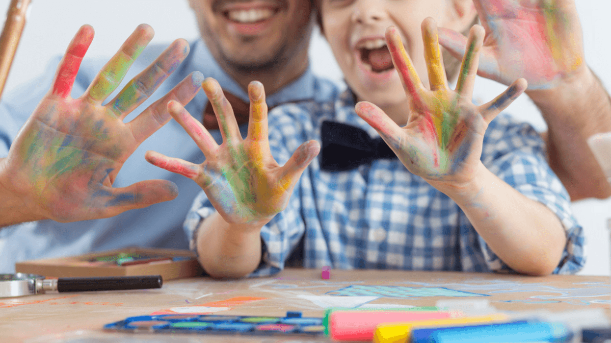 Young man creating art with child