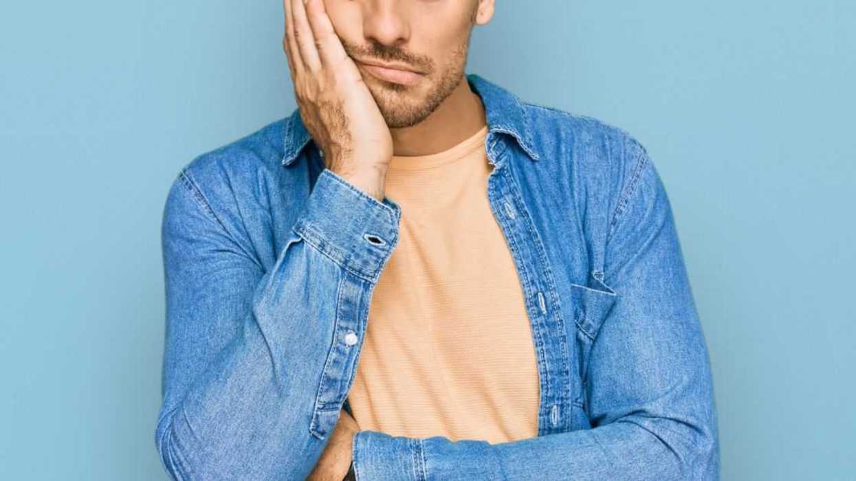 Young man wearing casual clothes thinking looking irritated with crossed arms.