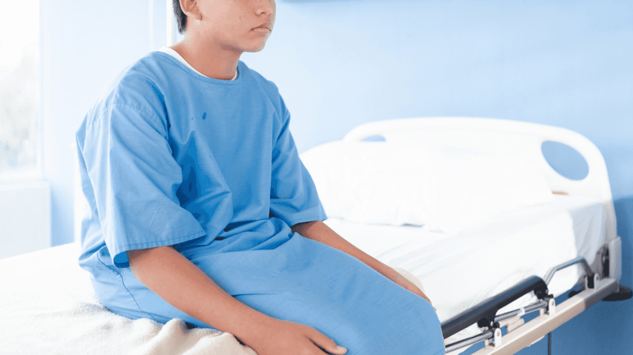 young person seated on hospital bed