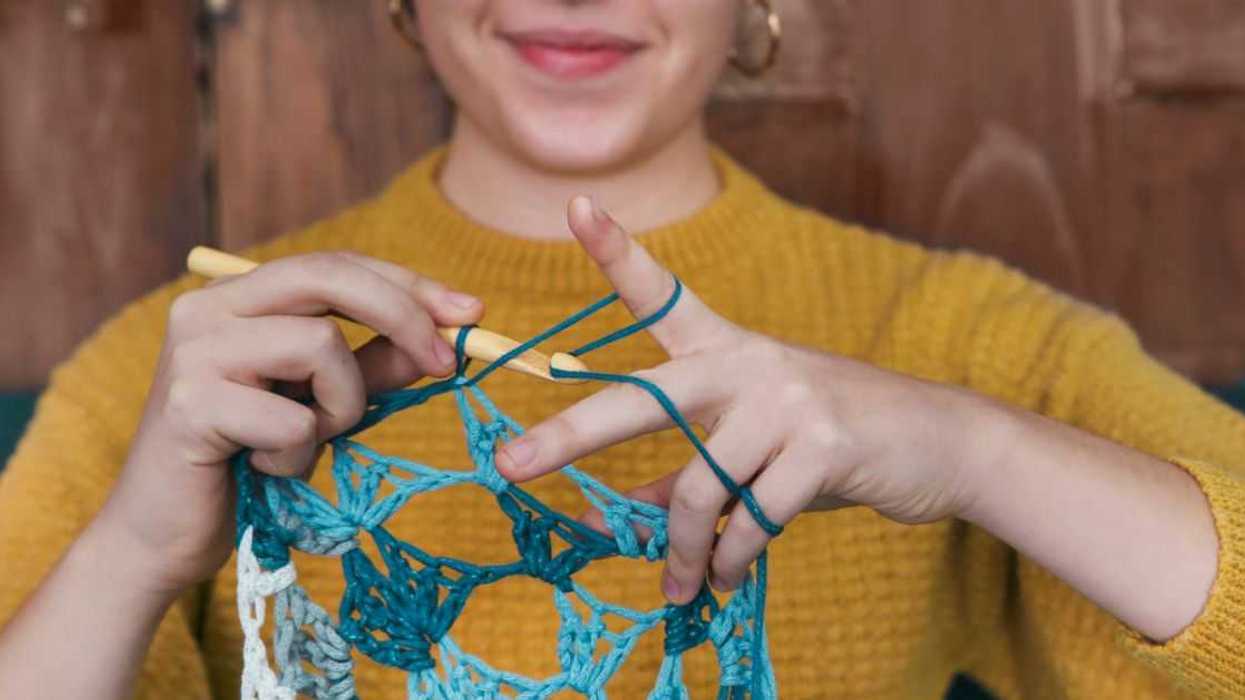 Young woman crocheting doily, close-up.