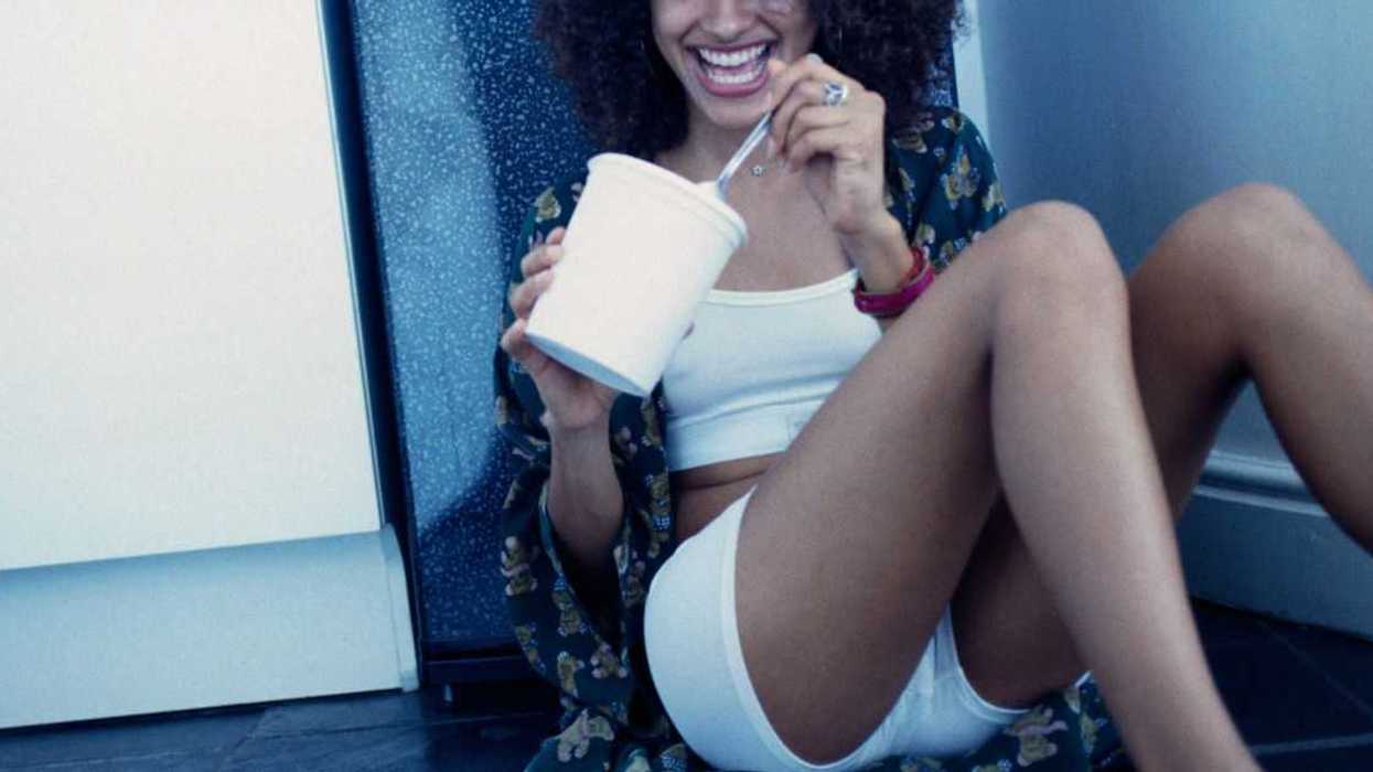 Young Woman eating ice cream out of carton