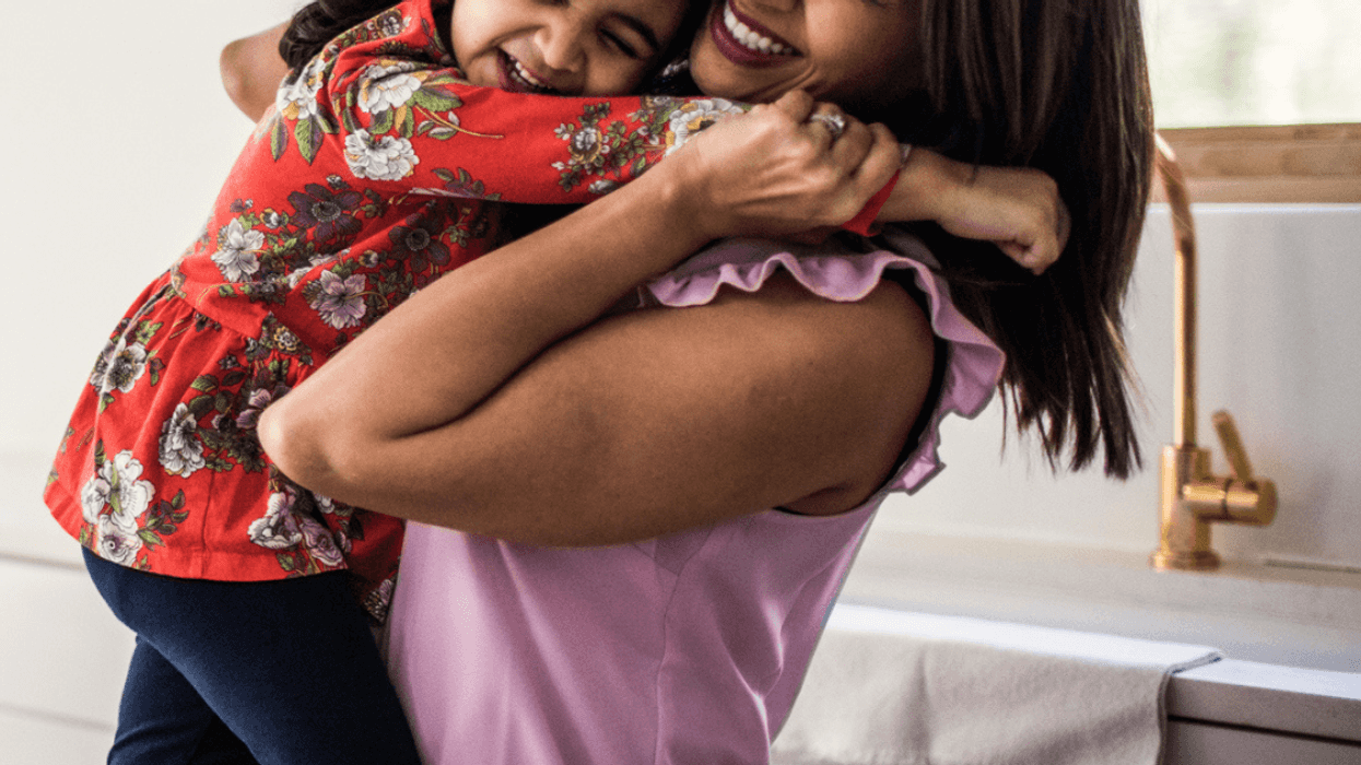 Young woman hugging a little girl