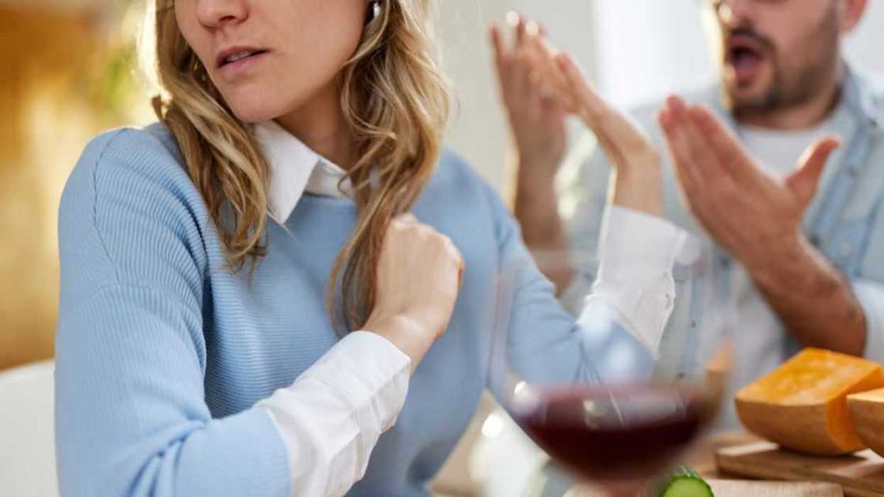 Young woman ignoring her boyfriend while arguing at home.