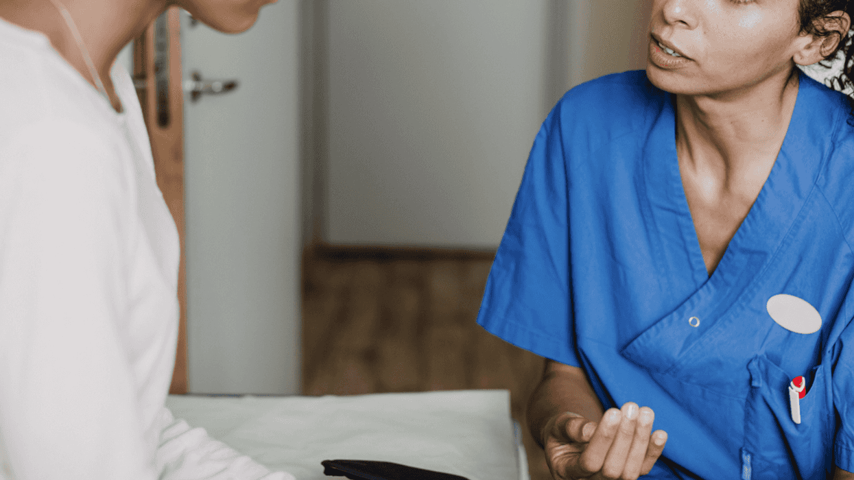 Young woman listening to nurse practitioner