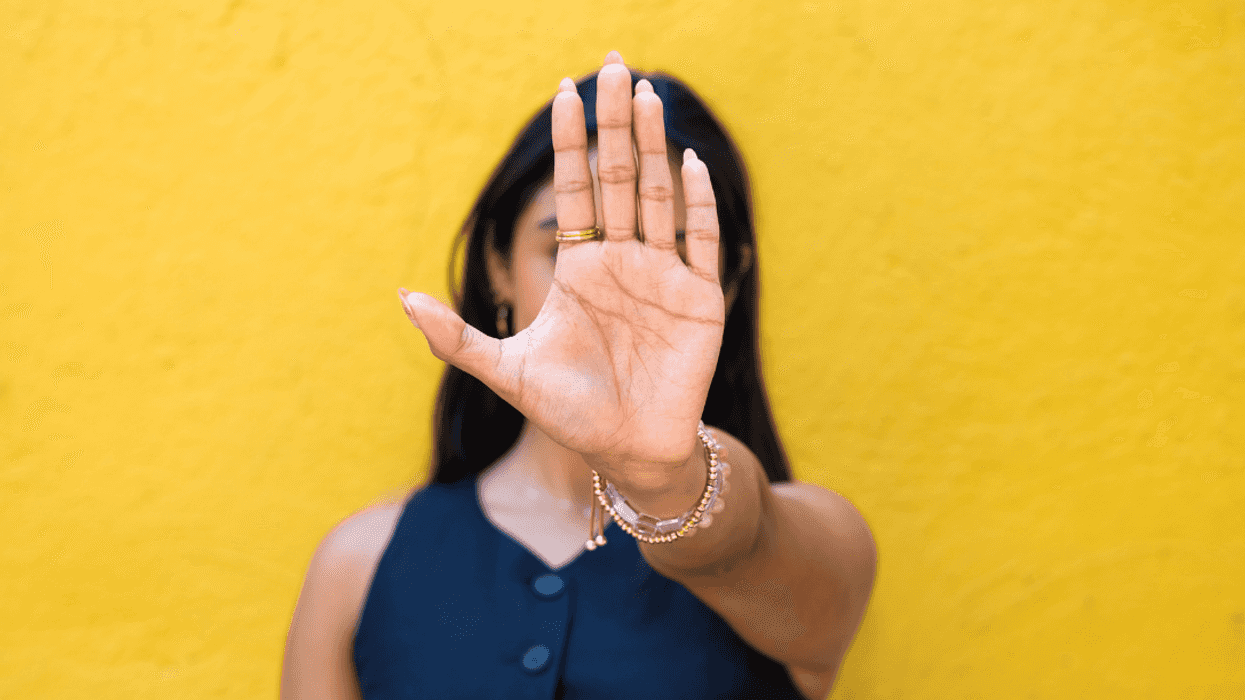 young women motioning someone to stop