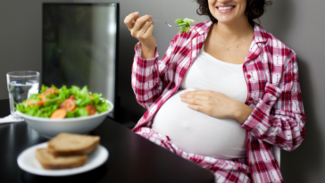 Pregnant woman enjoying vegetarian dinner