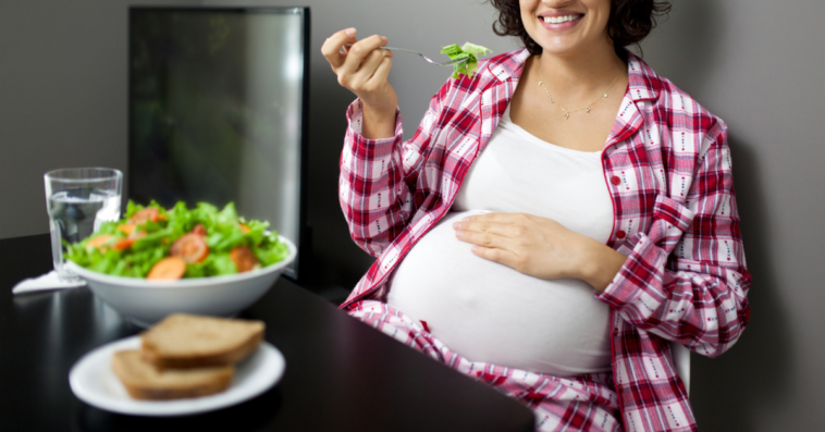 Pregnant woman enjoying vegetarian dinner