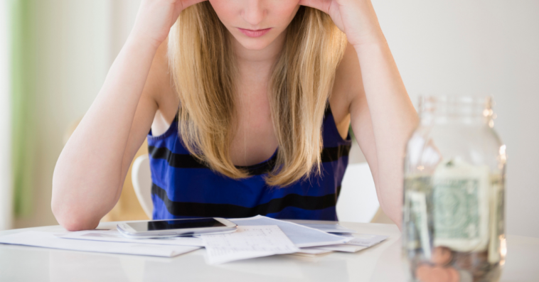 Woman stressed while creating a financial budget