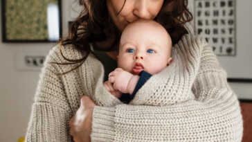 A woman protectively holding her baby