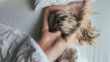 A woman sleeps topless