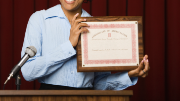 Woman holding award certificate