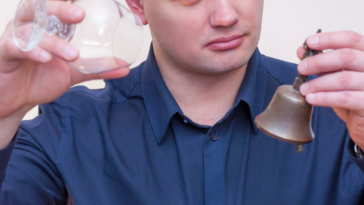 Man ringing small bell when his glass is empty