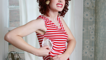 woman grimacing while trying to zip up a tight dress
