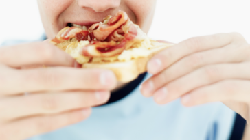 Teenage Boy Eating Bacon