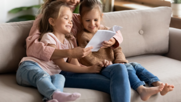 Babysitter reading to two young girls