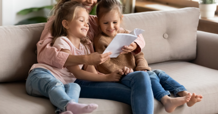 Babysitter reading to two young girls
