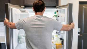 Man looking into refrigerator