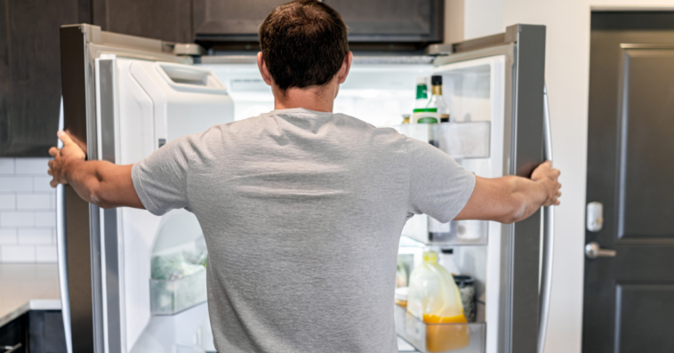 Man looking into refrigerator