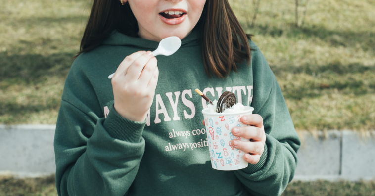 Young teen girl eating Oreos and ice cream