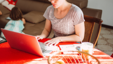 Young woman working from home with children