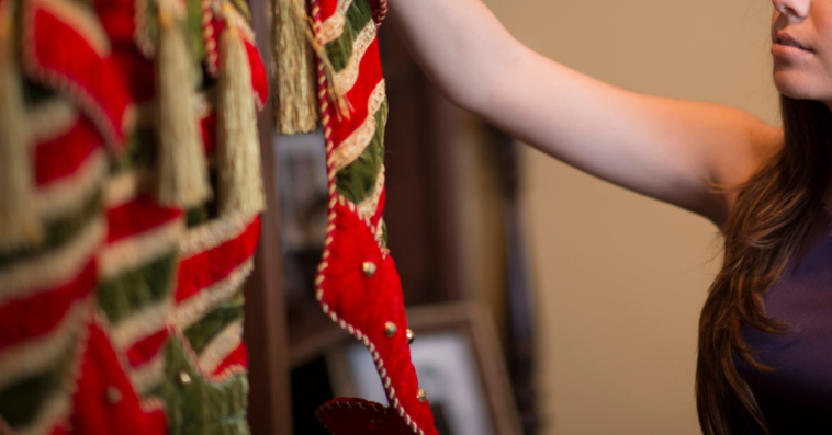 Woman hanging Christmas stockings