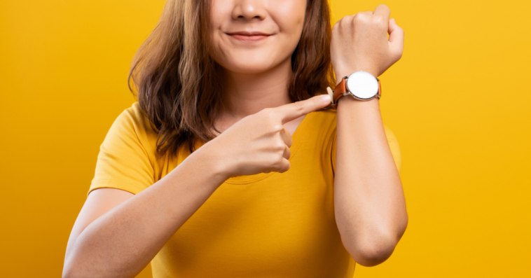 Frustrated woman gesturing to her watch