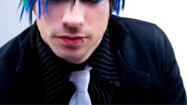 Picture of a punk rock guy, colorful hair, lip ring