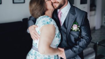 A mother and son embrace at a wedding