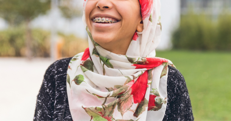 Teen Muslim girl smiling and wearing hijab