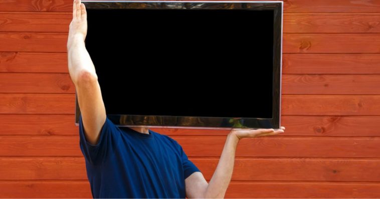 Man holding TV set